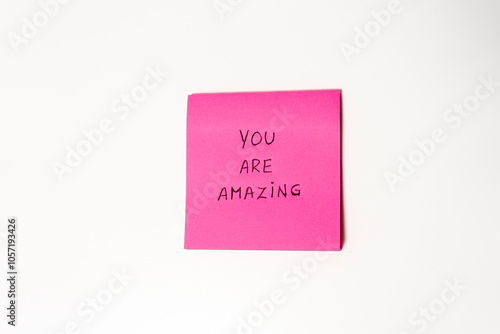 You are amazing. It is written on a pink sticky note.