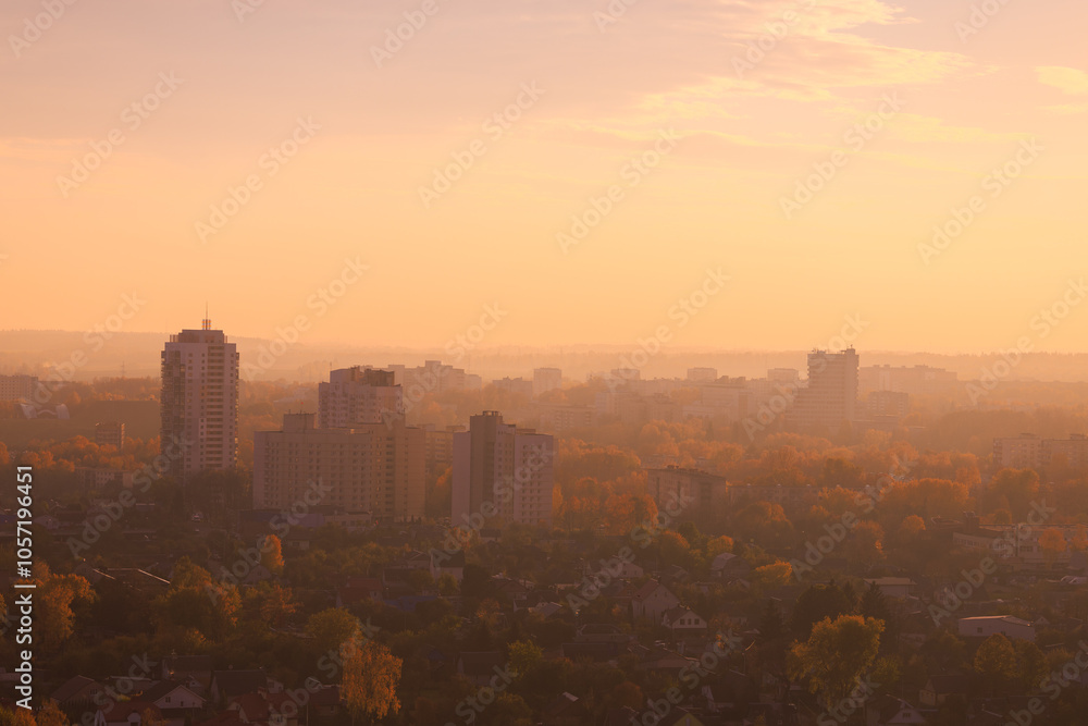 Fototapeta premium Evening view of the city. Sunset orange sky and beautiful cityscape, buildings and city streets, public place