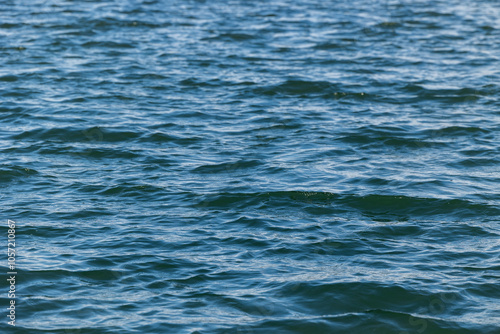 vista dettagliata di una superficie d'acqua dalle sfumature di colore azzurro e verde scuro, di un fiume o del mare, di giorno photo