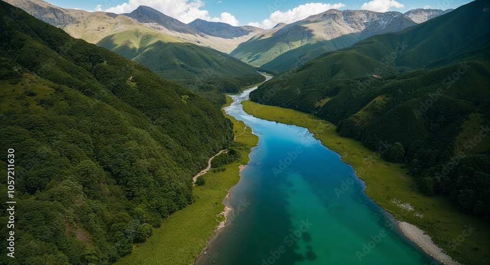 Aerial of lush mountain with clear river flowing through Aerial of lush mountain with clear river flowing through