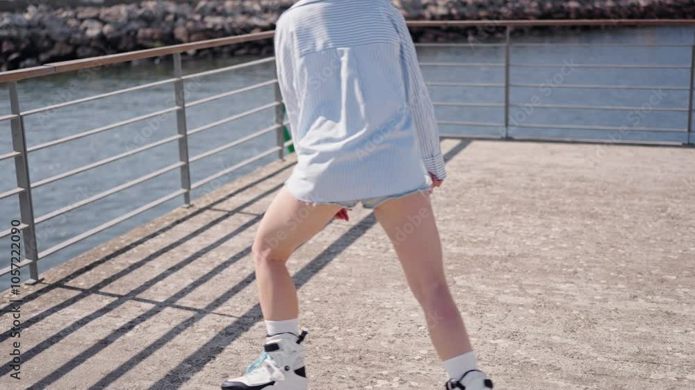 Woman roller skating on a sunny day by the waterfront, embracing outdoor fitness and relaxation. Woman roller skating on a sunny day by the waterfront, embracing outdoor fitness and relaxation.