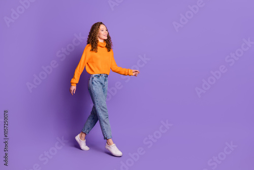 Full length portrait of lovely young girl walk empty space wear sweater isolated on purple color background