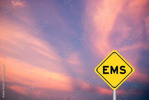 Yellow transportation sign with word EMS (abbreviation of emergency medical services or express mail service) on violet color sky background photo