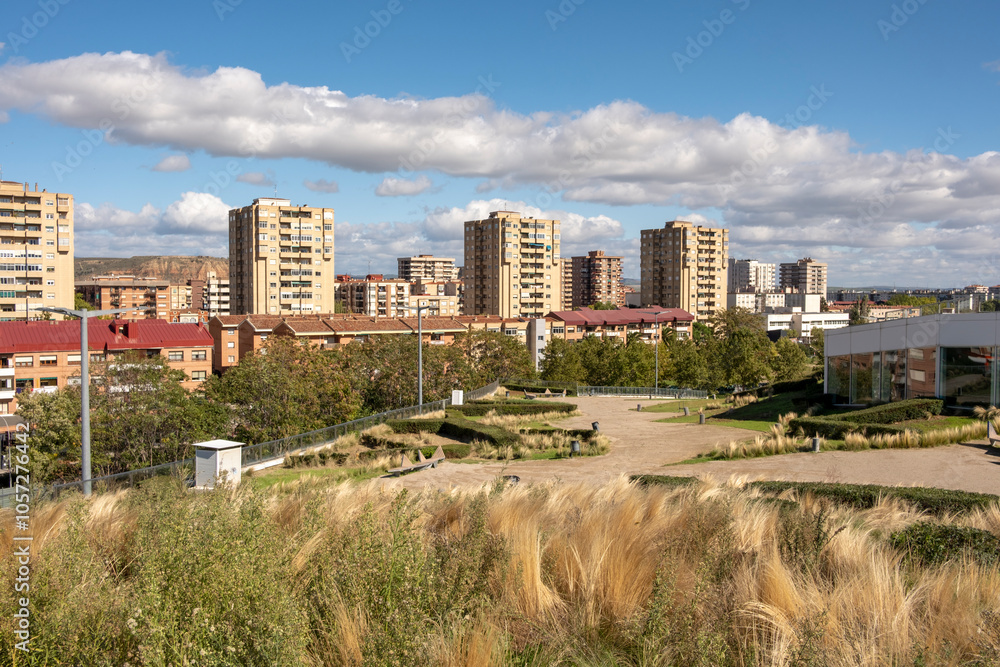 A sprawling urban skyline dotted with high-rise apartment blocks, a view that merges urban architecture with lush greenery reflecting vibrant city life in Logrono Spain A sprawling urban skyline dotted with high-rise apartment blocks, a view that merges urban architecture with lush greenery reflecting vibrant city life in Logrono Spain