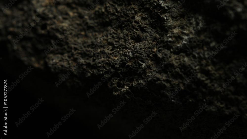 Rough dark stone texture with natural pits Rough dark stone texture with natural pits