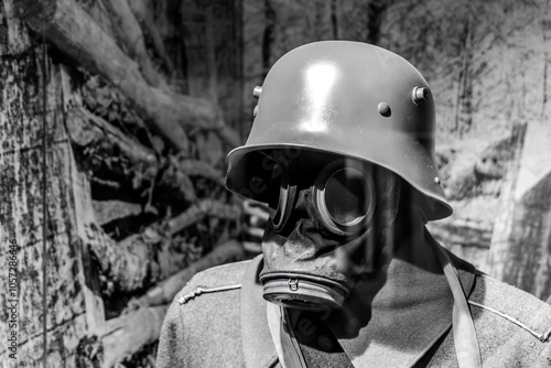 Φωτογραφία Close-up of a world war one soldier wearing a gas mask and helmet in black and w