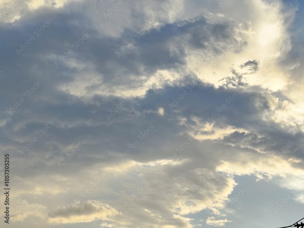 A beautiful sky filled with white clouds and bright sunlight, creating a dramatic landscape that captures the essence of a summer day A beautiful sky filled with white clouds and bright sunlight, creating a dramatic landscape that captures the essence of a summer day