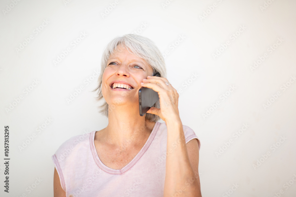 Happy mature woman talking on smartphone and smiling Happy mature woman talking on smartphone and smiling