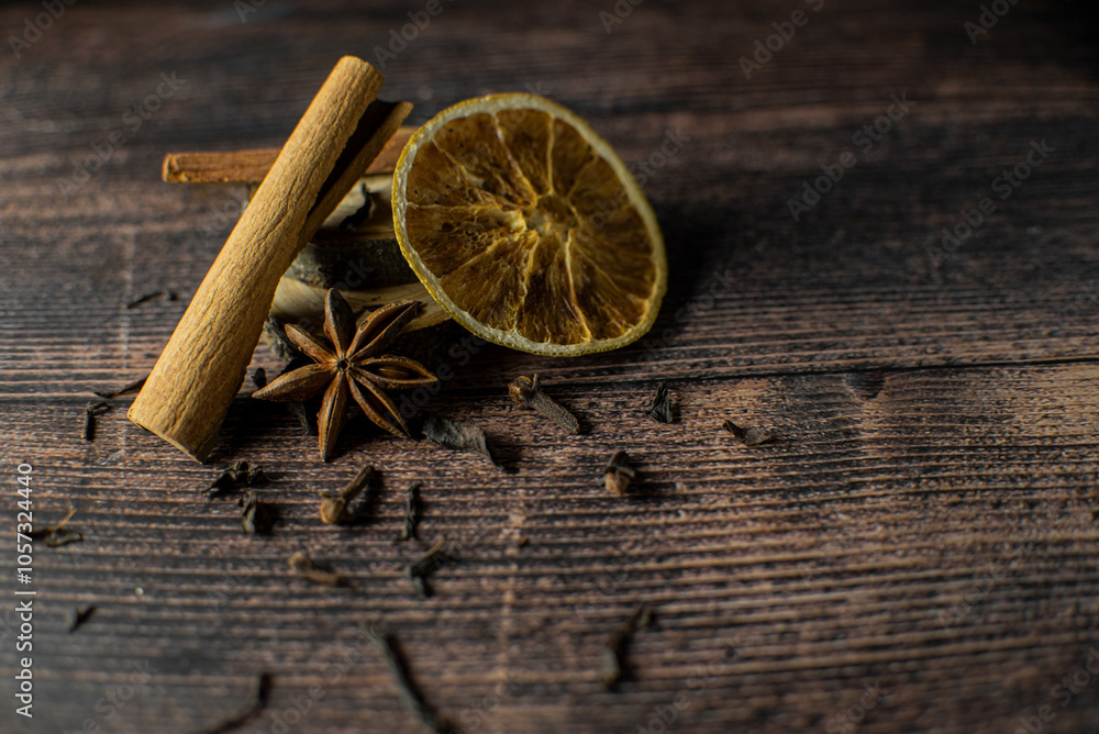 spices for tea cinnamon, star anise, cloves, orange, and glen wine on a dark wooden background spices for tea cinnamon, star anise, cloves, orange, and glen wine on a dark wooden background