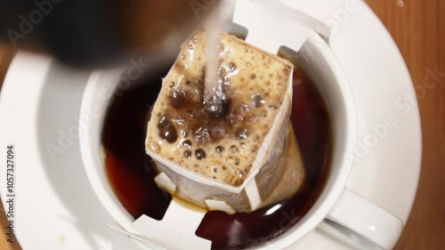 add milk to coffee drink..Milk is poured into coffee..Cup of coffee with milk on a white background, top view. photo