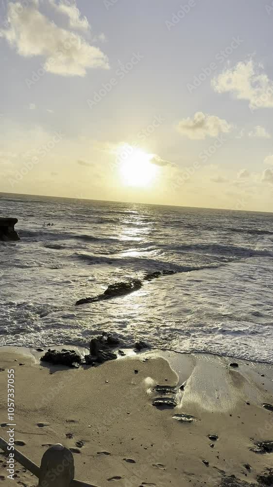 Sun setting over the wavy ocean Sun setting over the wavy ocean