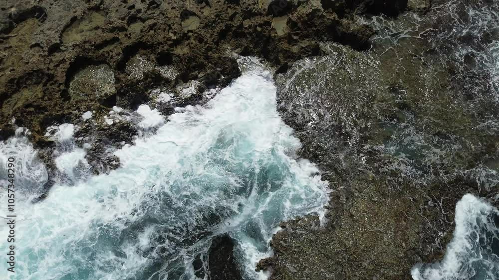 Beautiful Caribbean sea coast with deep blue ocean water crashing on the rocks and cliffs and making waves on the sunny tropical island of Curacao - aerial drone flight shot Beautiful Caribbean sea coast with deep blue ocean water crashing on the rocks and cliffs and making waves on the sunny tropical island of Curacao - aerial drone flight shot
