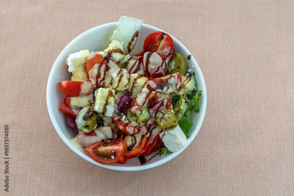 Greek salad with 3 California peppers, cherry tomatoes, endive lettuce, feta cheese, green olives, red onion, grissini and sauce.