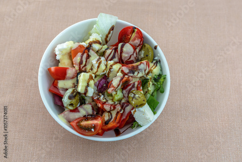 Greek salad with 3 California peppers, cherry tomatoes, endive lettuce, feta cheese, green olives, red onion, grissini and sauce.