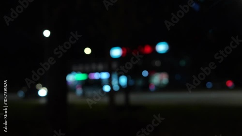 Blurred city lights at night creating soft urban bokeh and atmospheric street mood

