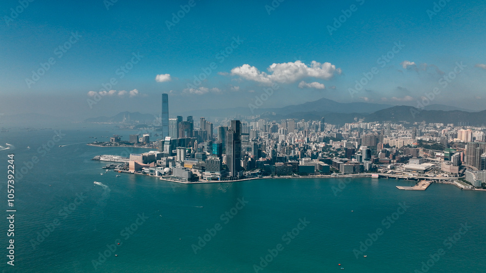 Aerial view of Hong Kong skyline and harbor under clear blue sky during bright daylight Aerial view of Hong Kong skyline and harbor under clear blue sky during bright daylight