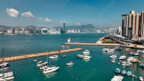 A vibrant view of Hong Kong harbor filled with yachts against a clear blue skyline