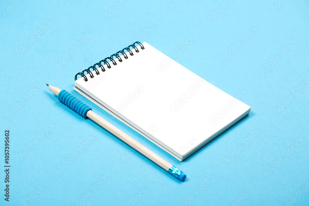 Spiral notepad with pencil as mockup for your design. Note book on pastel blue background. Spiral notepad with pencil as mockup for your design. Note book on pastel blue background.