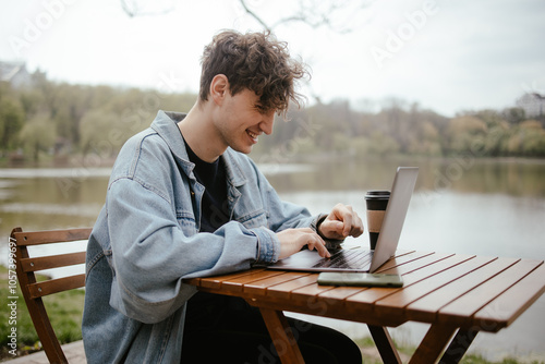 Young Man Working by Lake