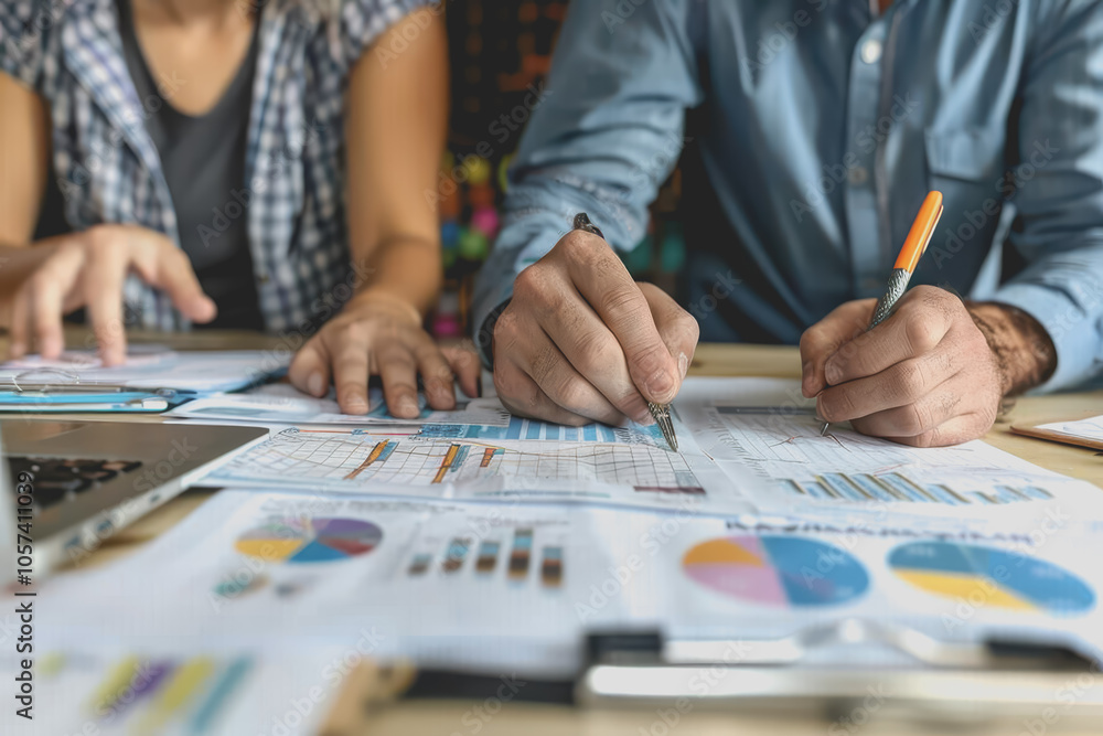 Hands business team having a meeting to analyze data graph charts for a marketing plan in the office Hands business team having a meeting to analyze data graph charts for a marketing plan in the office