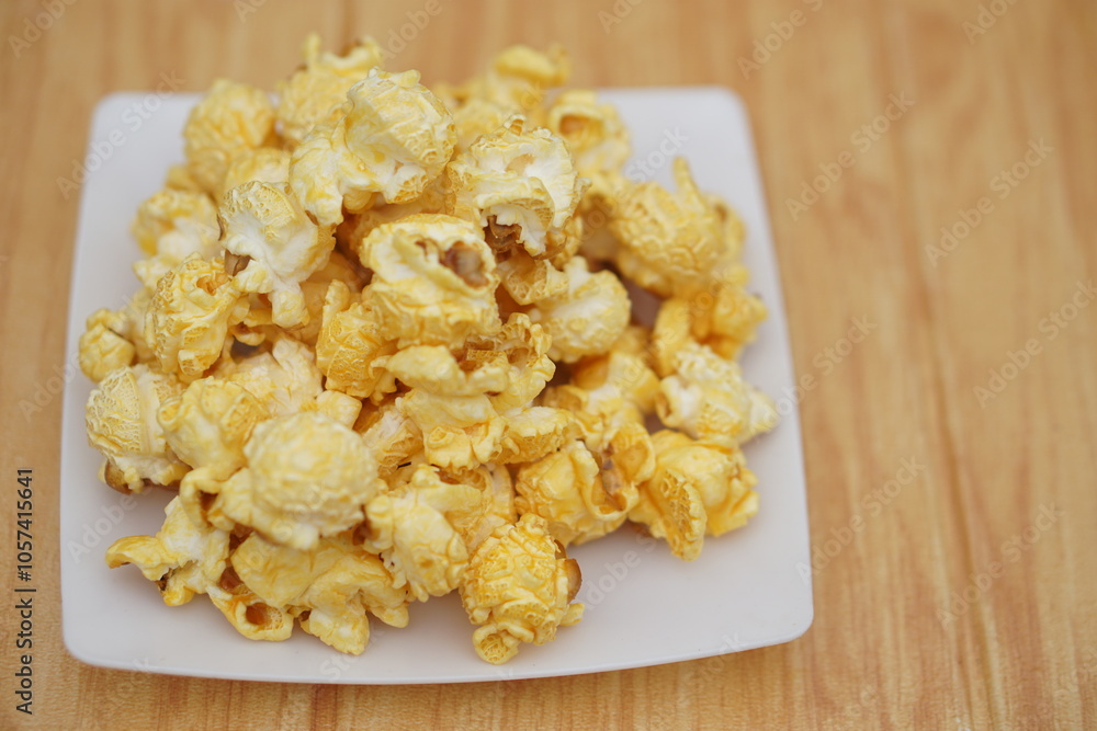 Homemade popcorn, made from seeds of maize or corn by baking or heating, mixed with salt, sugar and butter caramel. Concept, delicious snack. Agriculture product as food. Homemade popcorn, made from seeds of maize or corn by baking or heating, mixed with salt, sugar and butter caramel. Concept, delicious snack. Agriculture product as food.