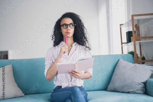 Portrait of pretty young girl pen notepad contemplate wear striped shirt white interior modern flat indoors