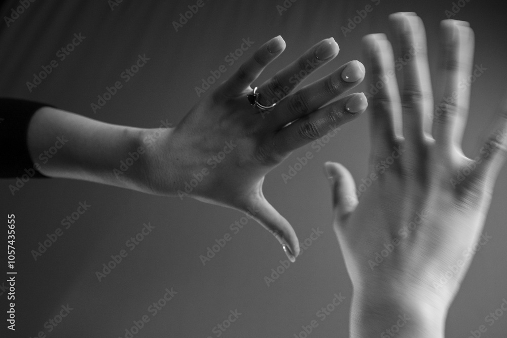 Two human hands making delicate and expressive gestures against a plain ...