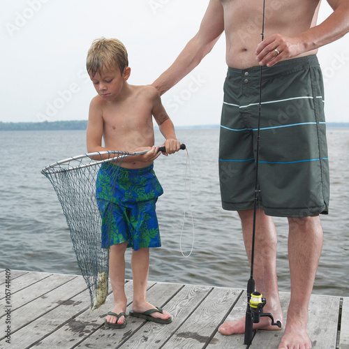 Father and Son Fishing on Dock photo