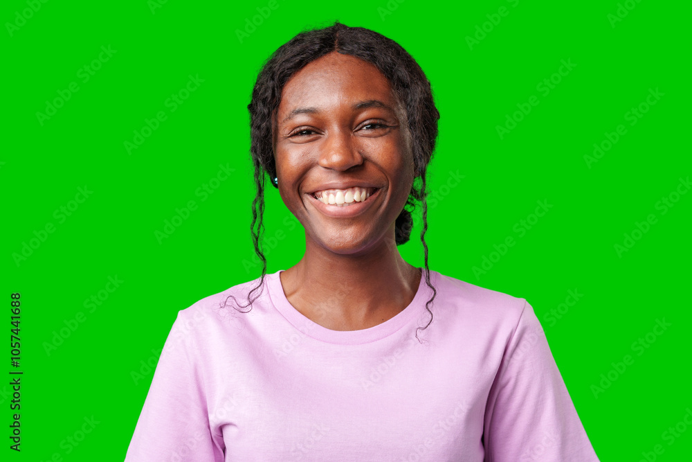 Young woman smiling joyfully in a pink shirt against a vibrant green background in a cheerful atmosphere Young woman smiling joyfully in a pink shirt against a vibrant green background in a cheerful atmosphere