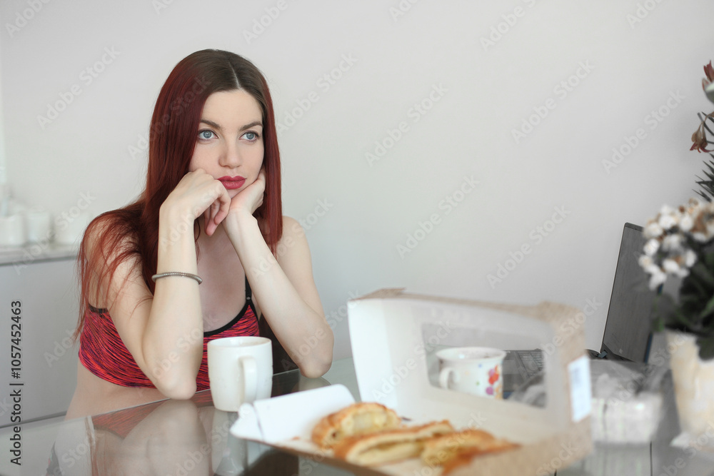 happy woman having breakfast in the kitchen happy woman having breakfast in the kitchen