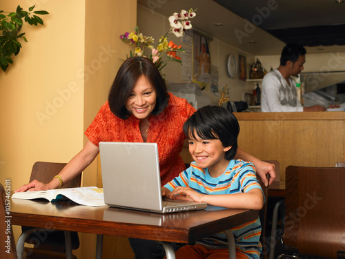 Boy and Mother with Homework in Restaurant photo