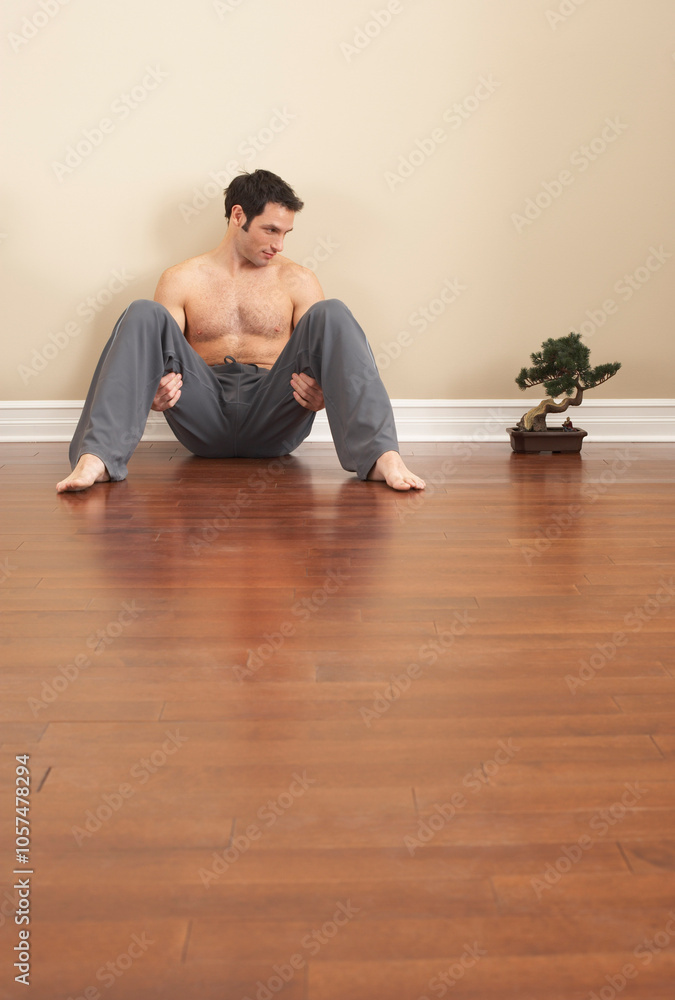 Man Sitting on Floor by Bonsai Tree Man Sitting on Floor by Bonsai Tree