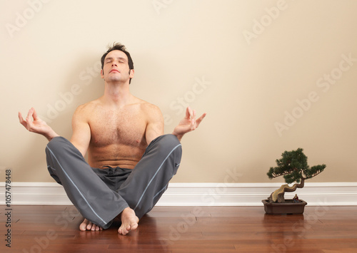 Man Sitting on Floor with Bonsai Tree photo