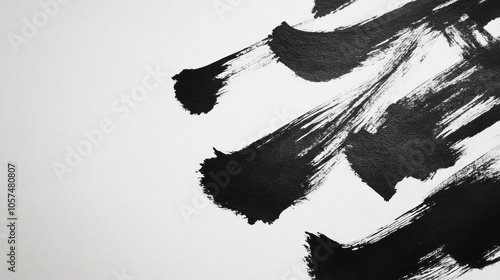 Abstract black brush strokes on a white canvas, emphasizing contrast and artistic expression. photo