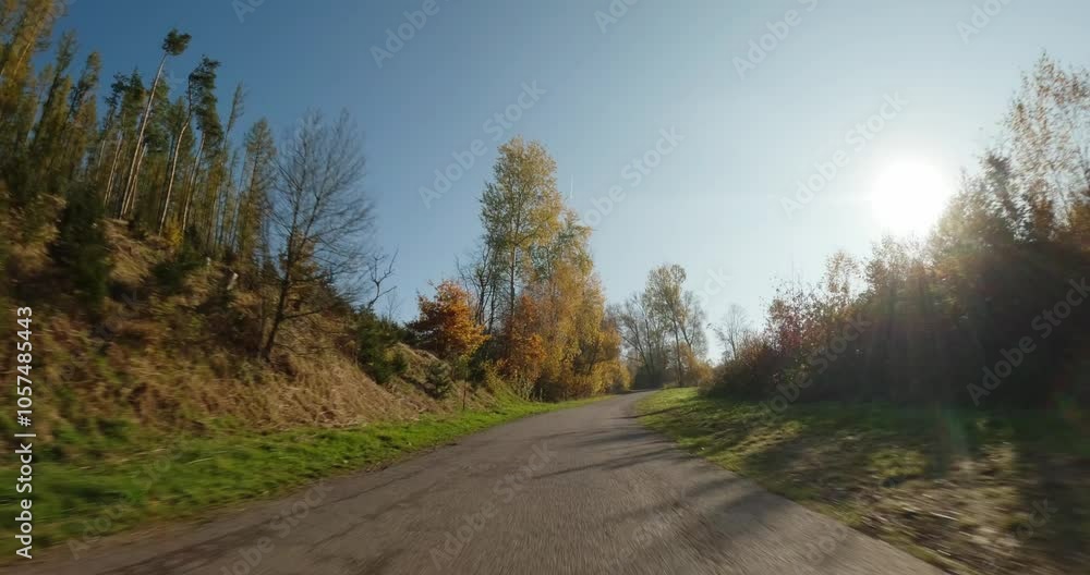 Car drive in fall autumn landscape, POV view from car, fall colored trees in countryside landscape with blue sky in sunny day. Car drive in fall autumn landscape, POV view from car, fall colored trees in countryside landscape with blue sky in sunny day.