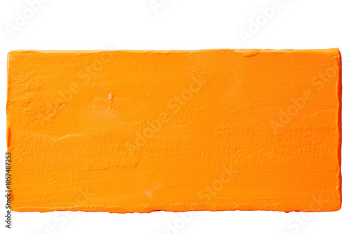 Close-up of thick orange paint block with textured surface isolated on white background photo