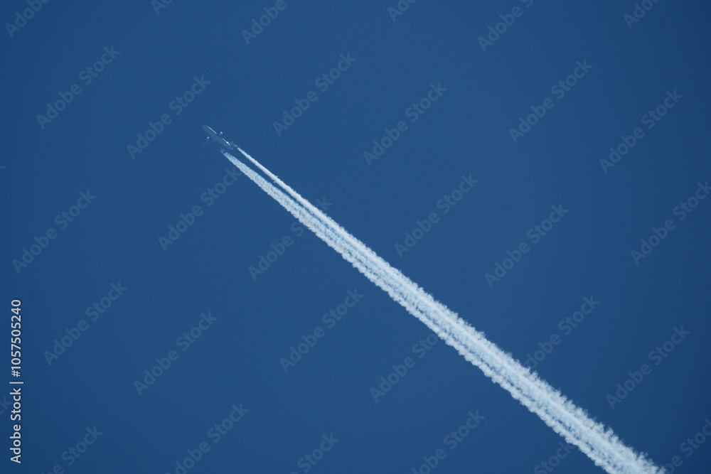 Airplane in the blue sky, with contrail Airplane in the blue sky, with contrail