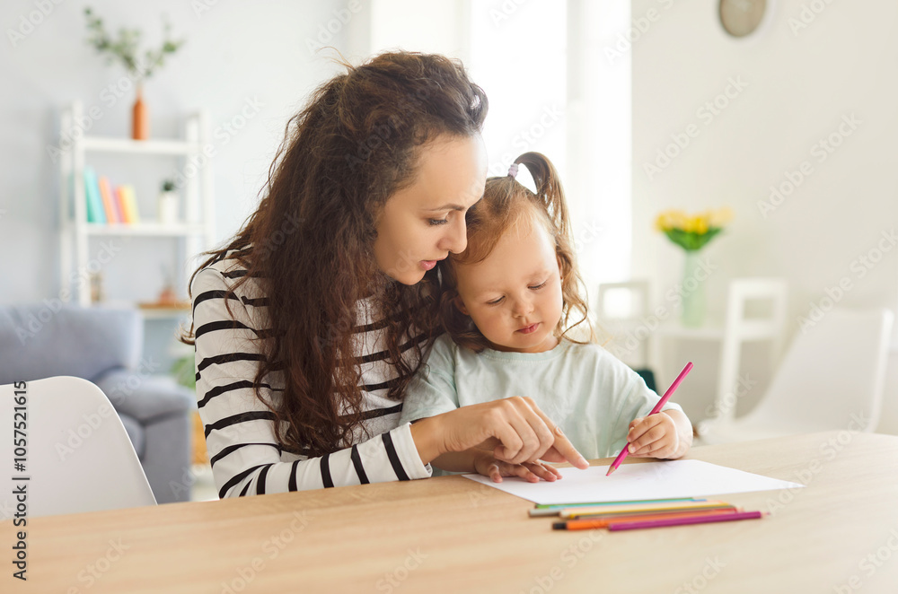 Mother and daughter enjoy a creative time together at home, painting and drawing to foster education and family leisure. Activity builds a connection through shared artistic expression. Mother and daughter enjoy a creative time together at home, painting and drawing to foster education and family leisure. Activity builds a connection through shared artistic expression.