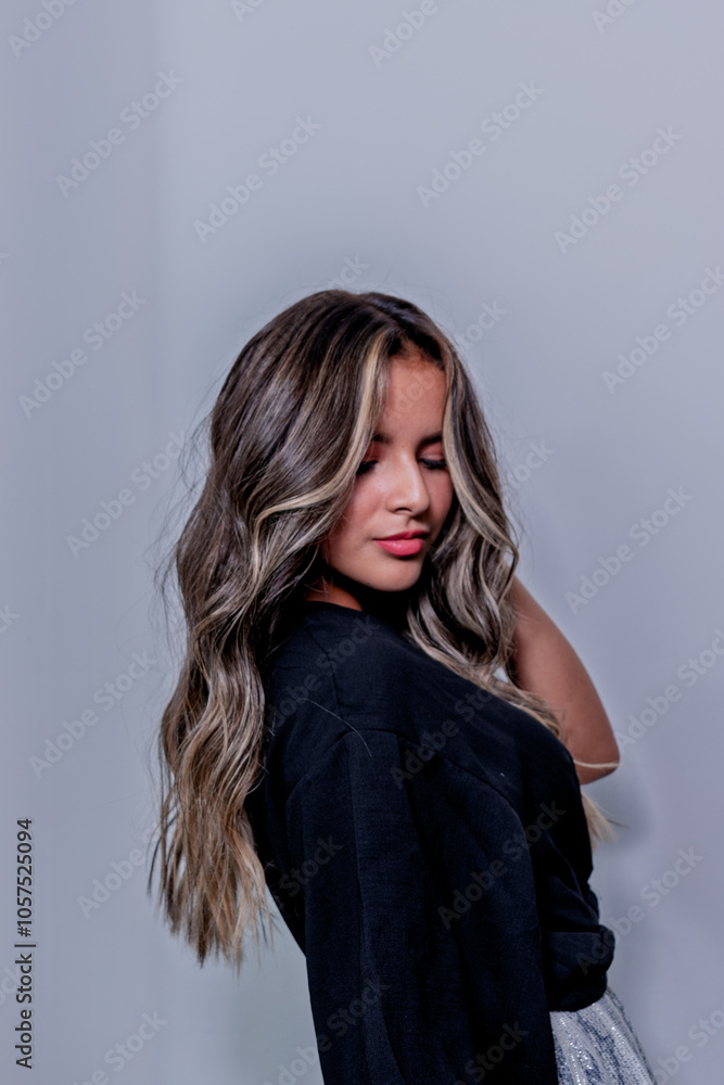 Fototapeta premium Young Hispanic, Latina, Peruvian woman in front of the camera playing with her hair, with different expressions 