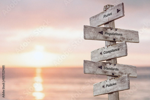 rules regulations compliance standards policies text quote written on wooden sign outdoors by the sea