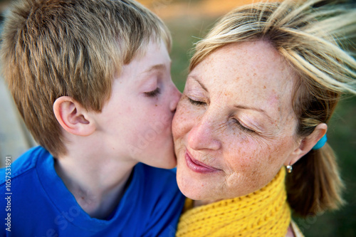 Young son gives his mother a kiss; Lincoln, Nebraska, United States of America photo