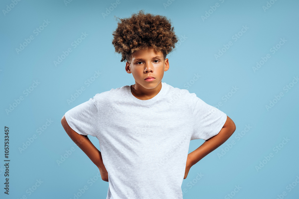 Serious, pensive, African American teenager, boy with curly hair wearing white t shirt with mockup Serious, pensive, African American teenager, boy with curly hair wearing white t shirt with mockup