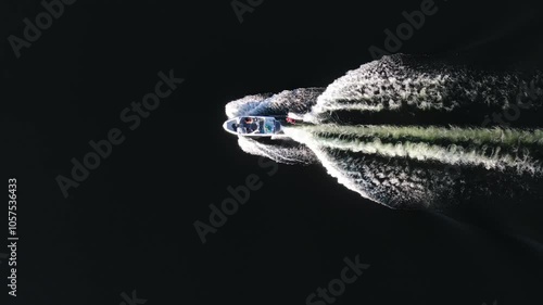 A boat rides on a lake with a wakesurf rider