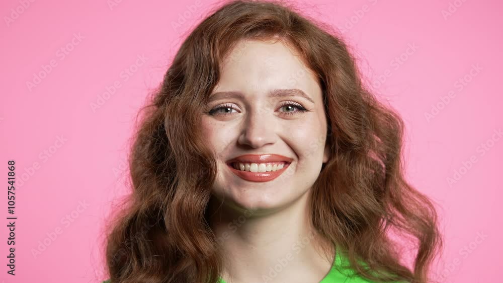 Gorgeous woman in green outfit showing yes signal, nods head, approve. Positive smiling european girl, body language. Correct perfect choice, great deal. Pink studio background Gorgeous woman in green outfit showing yes signal, nods head, approve. Positive smiling european girl, body language. Correct perfect choice, great deal. Pink studio background