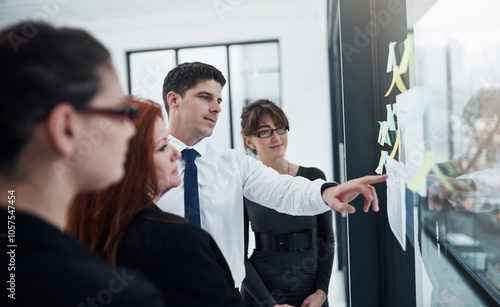 Colleagues, group and reading of sticky notes, glass and collaboration for brainstorming and ideas. Communication, teamwork and corporate people with information, underwriter and insurance company photo