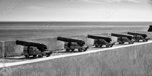 Row of cannons pointing out to the Atlantic ocean at Fortress of Sagres in the Algarve region of Portugal. Sagres sits at the extreme western tip of the Algarve region; Sagres, Faro, Portugal