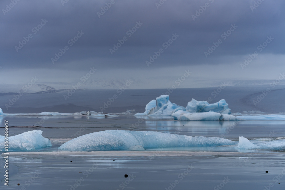 Icebergs floating on jokulsarlon glacier lagoon under a cloudy sky in iceland Icebergs floating on jokulsarlon glacier lagoon under a cloudy sky in iceland