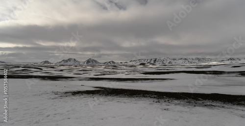 Snow covered landscape meeting dramatic cloudy sky in iceland