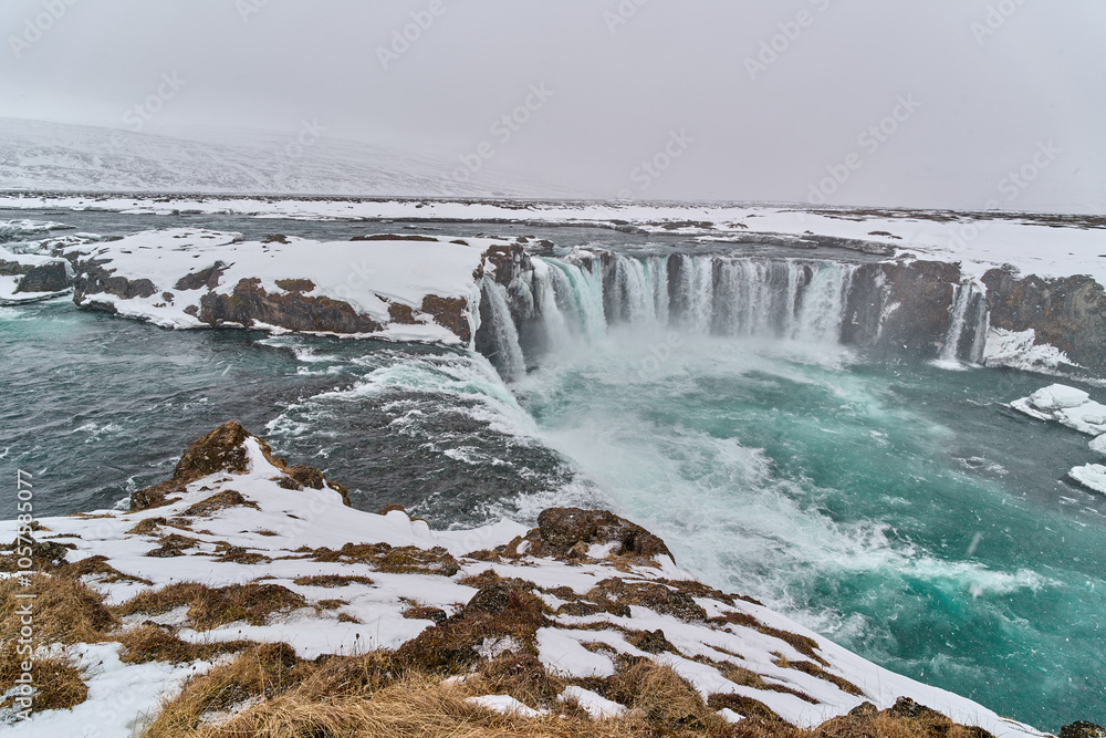 Godafoss waterfall cascading during snowfall in iceland Godafoss waterfall cascading during snowfall in iceland