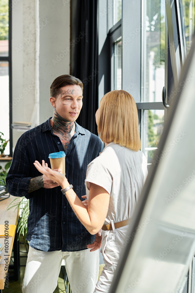 Two young professionals share ideas and laughter while enjoying coffee by the window. Two young professionals share ideas and laughter while enjoying coffee by the window.